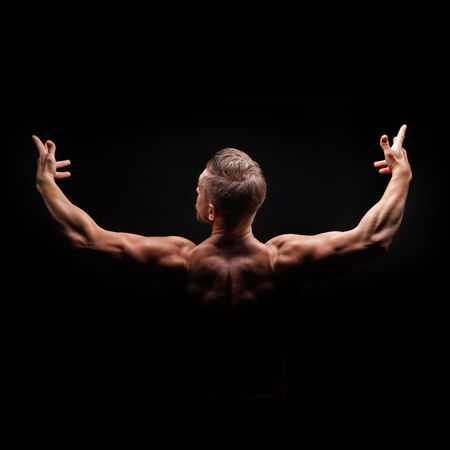Square studio shot of bodybuilders arms and shoulders