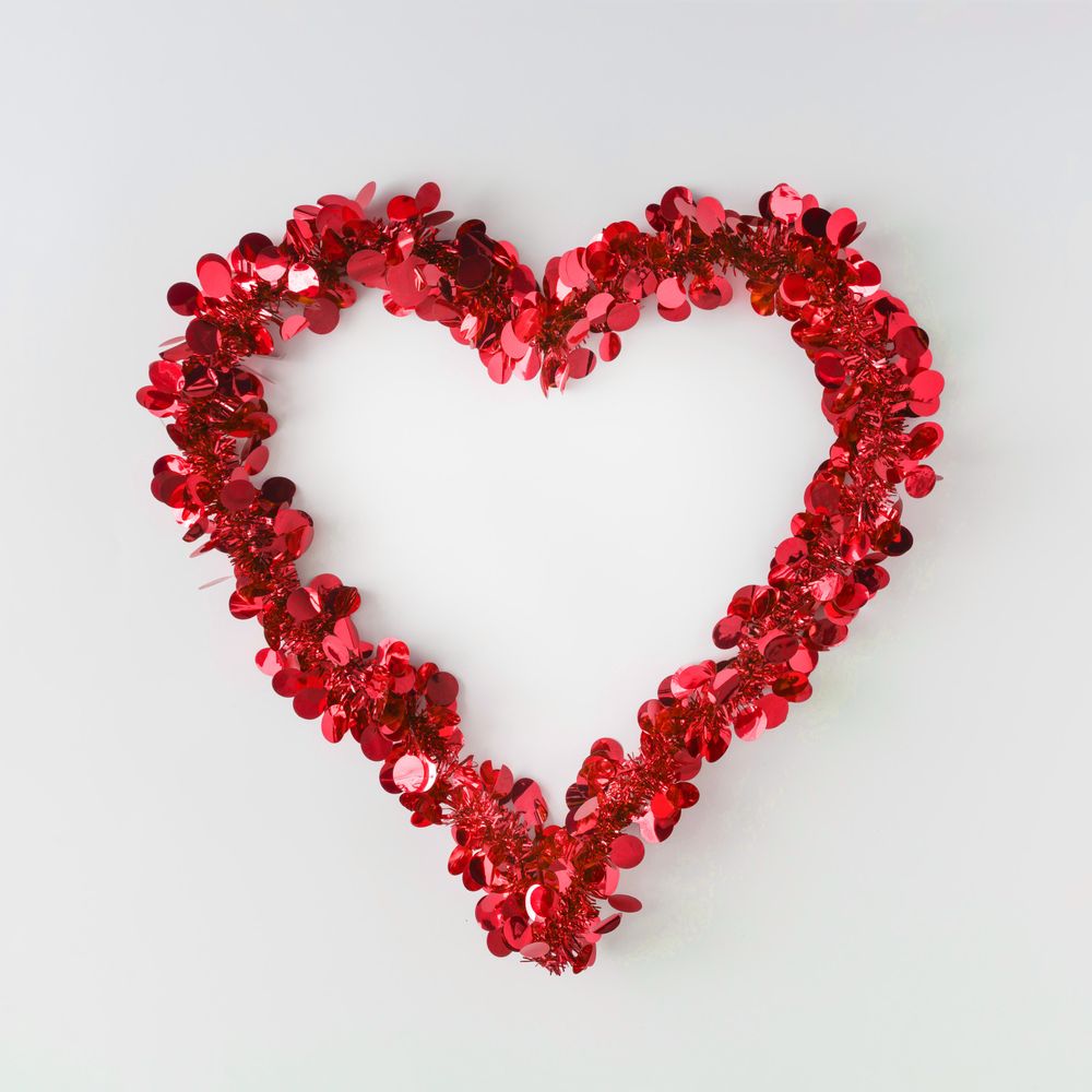 Red confetti shaped in heart outline on light background
