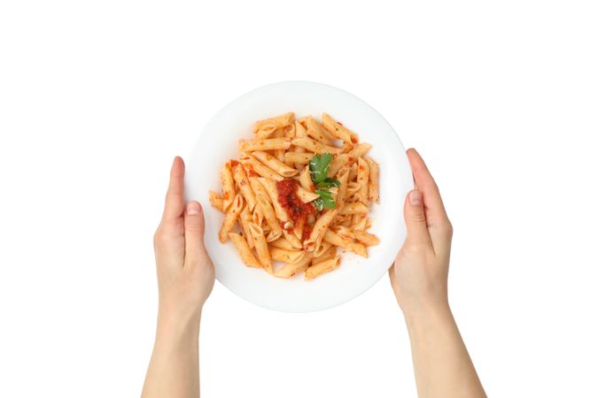 Hands hold plate with tasty pasta, isolated on blank background
