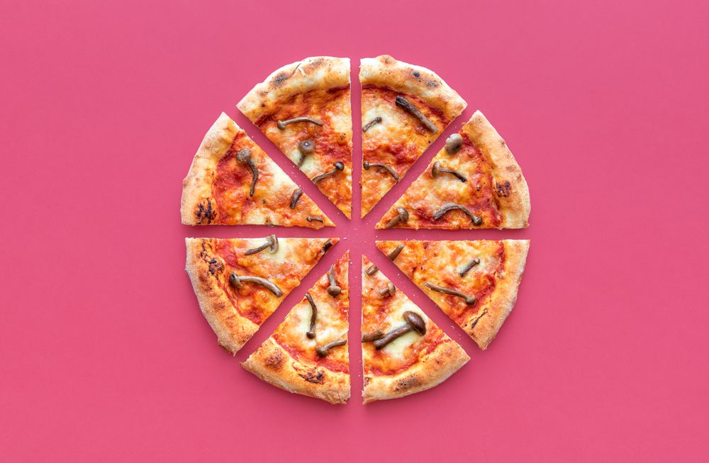 Sliced pizza top view on a magenta background