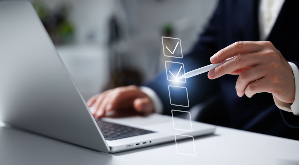 Businessman marking completed tasks hologram