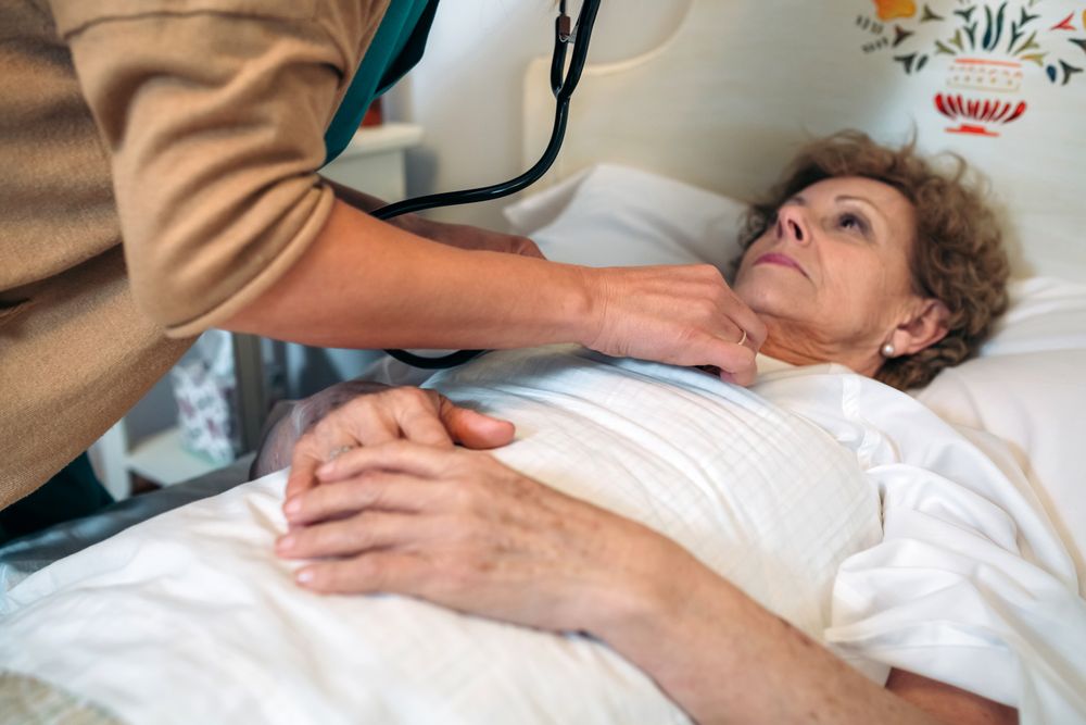 Caregiver auscultating woman