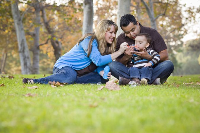 Family Playing with Bubbles In The Park