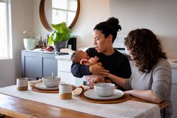 Two women with baby at their dining table