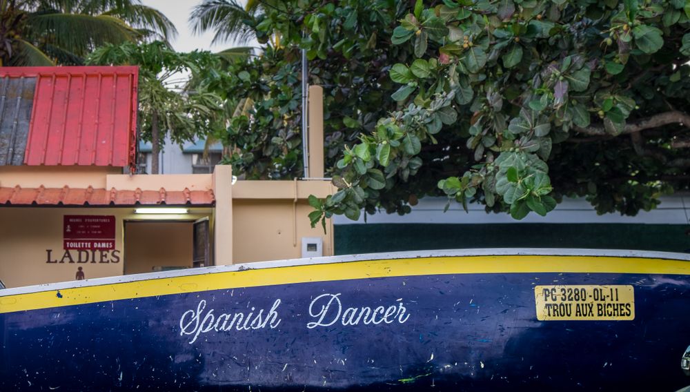 Boat in front of a public bathroom on the beach
