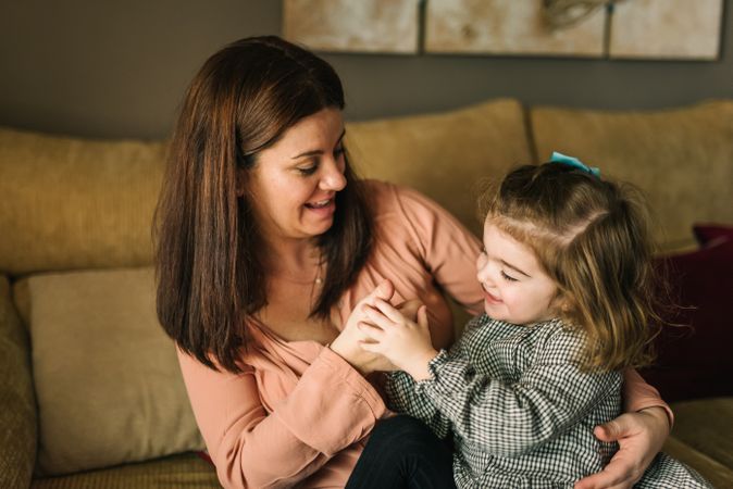 Woman hugging smiling daughter