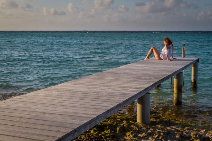 Young woman on pier near sea