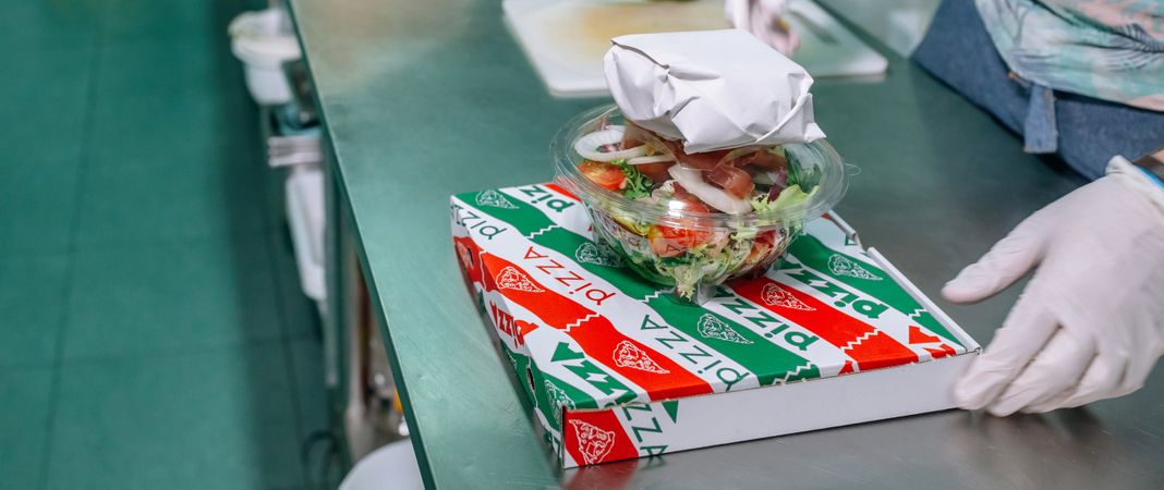 Unrecognizable chef with a food delivery order ready to go