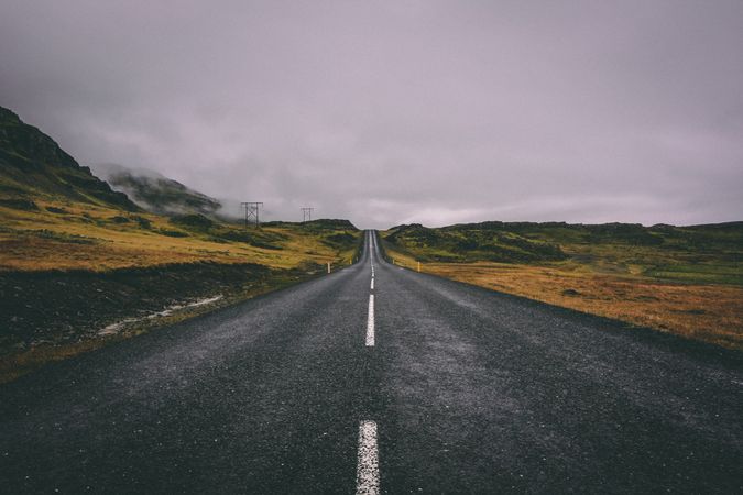Asphalt road under gray sky
