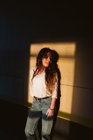 Smiling woman in spot of light