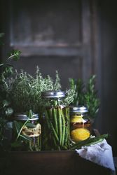Fresh green vegetables with fruits and glass jars