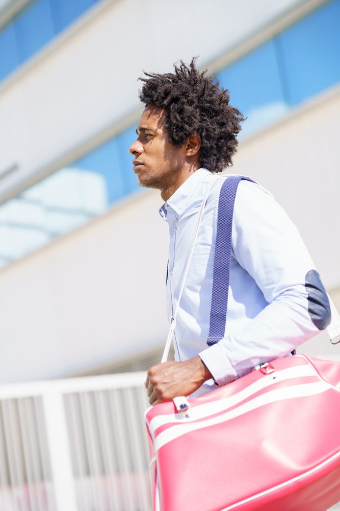 Man in smart casual leaving work with sports bag