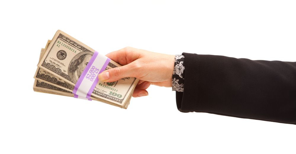 Woman Handing Over Hundreds of Dollars