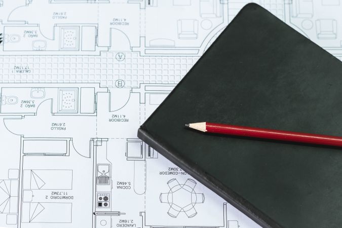 Notebook and pencil on an architectural design map
