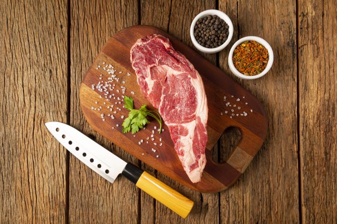 Raw ancho meat ready to roast on a wooden cutting board.