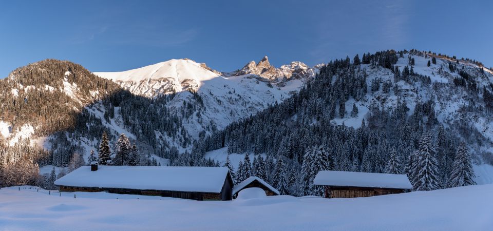 Winter landscape with mountain cabins in deep snow in the Bavarian Alps, Germany