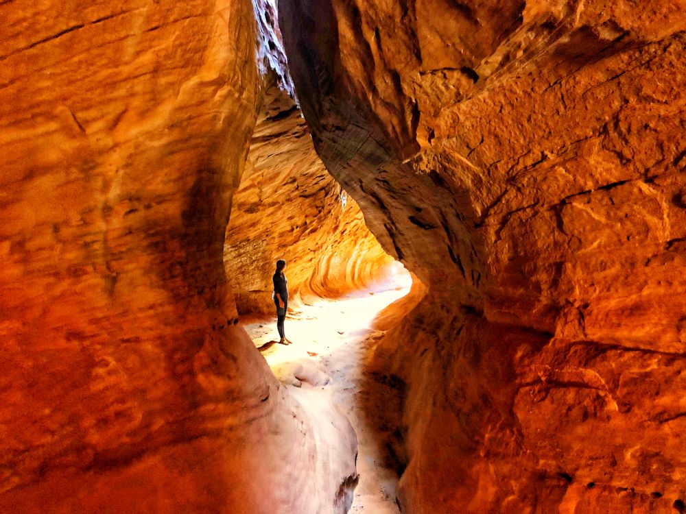 Person standing between rock formation