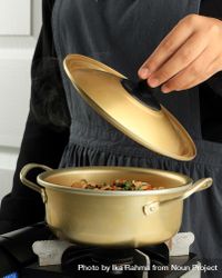 Cook opening brass pot while cooking noodles 0Lg7Eb