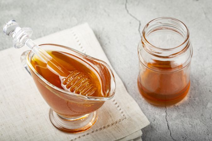 Honey in glass bowl on the table.
