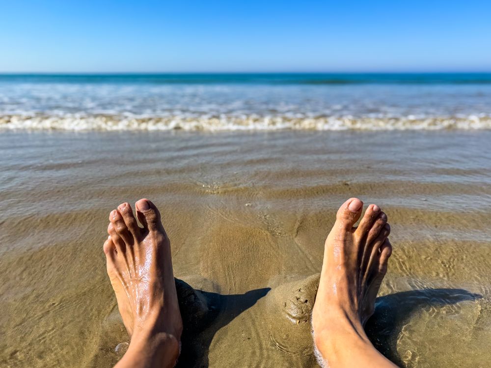 Wet feet in the sand at low tide, ile de Ré, France