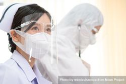Asian nurse in protective mask and face shield in hospital 0KWmZ0