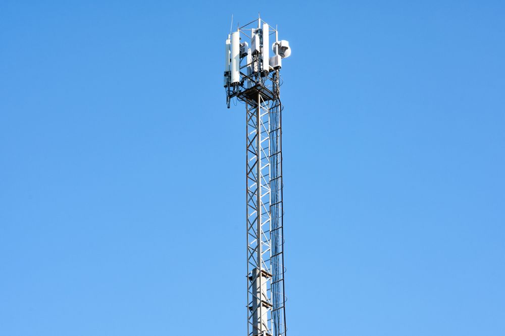Telecommunication Tower Against a Clear Blue Sky on a Sunny Day