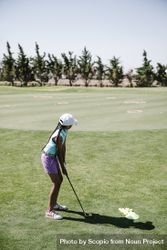 Back view of young girl playing golf 4BYyE5