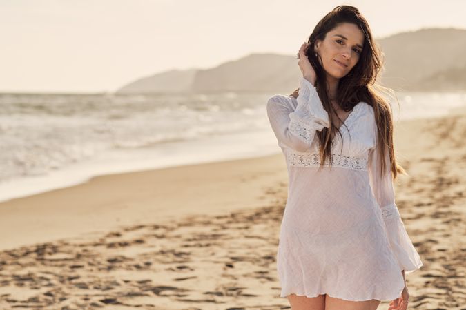 Young woman at the beach at sunset