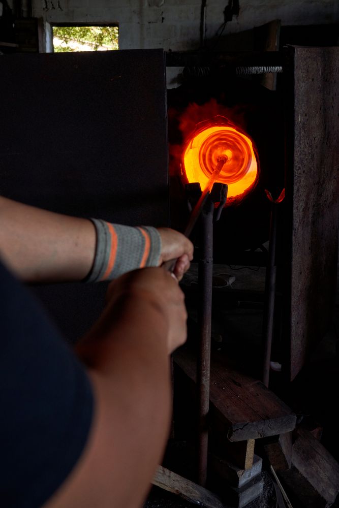 Unrecognizable male worker using melting furnace