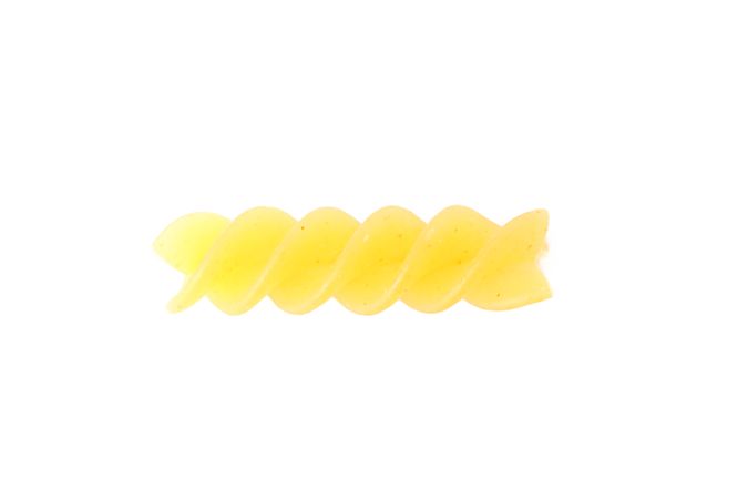 Pasta isolated on light background, closeup. Dry raw whole pasta
