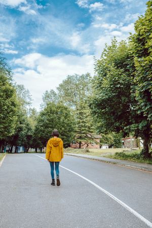 Anonymous woman walking along road