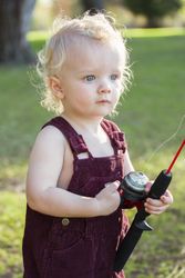 Cute Young Boy With Fishing Pole at The Lake