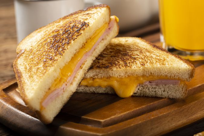 Grilled ham and cheese. Sandwich with cheese and ham on grill.