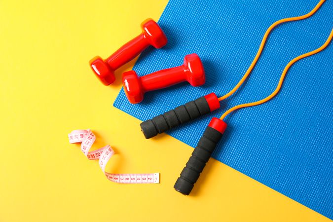 Flat lay composition with healthy lifestyle accessories on color background