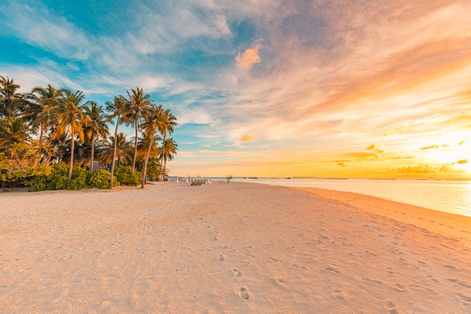 Beach water front under a blue and peach sky at sunset