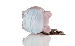 Financial bad times with piggy bank and spilled coins