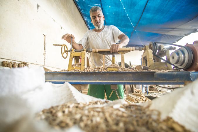 Man using woodworking machine at workplace