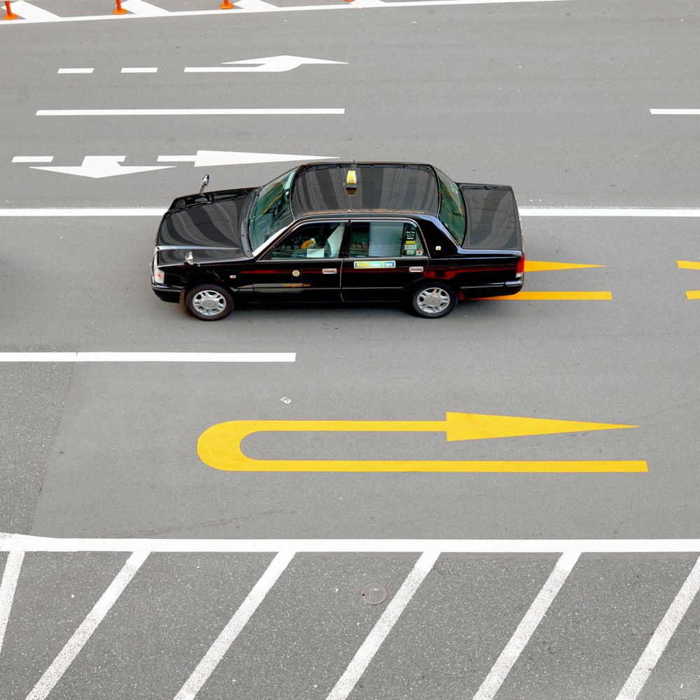 Top view of dark car taxi cab on the road during daytime
