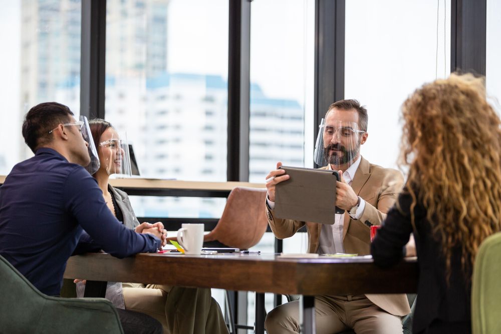 Group of people in meeting at wooden desk