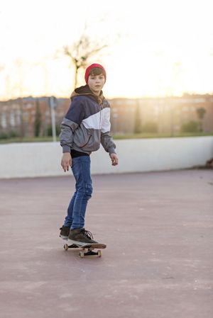 Young man riding on a skate in the city park