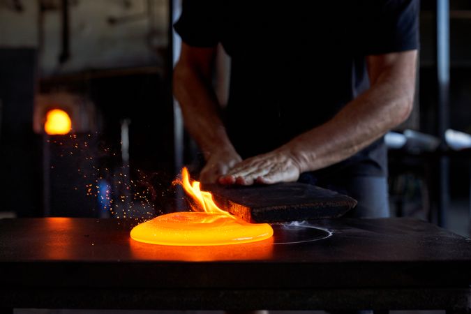 Crop craftsman working at glassblowing factory
