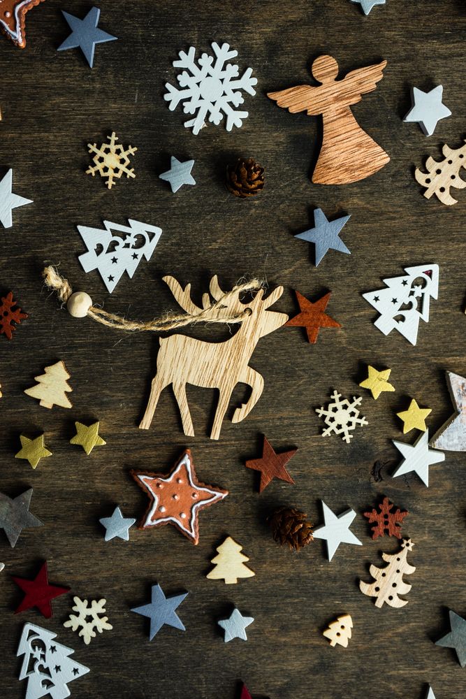Top view of flat cut out Christmas ornaments scattered on table