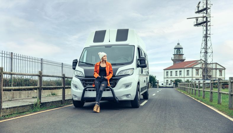 Female leaning in front of parked van