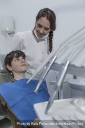 A teenage boy is being examined by a professional female dentist 56jzP5