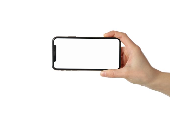 Female hand holding phone with empty screen, isolated on plain background
