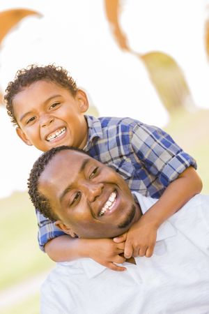 Black Father and Son Playing Piggyback in Green Park
