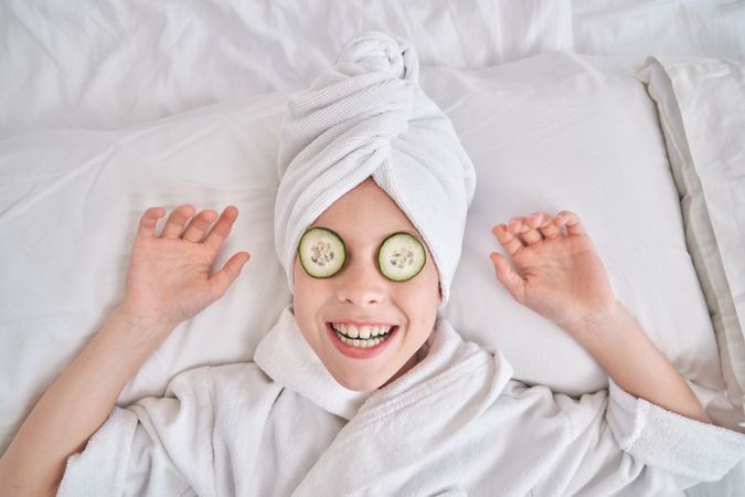 Playful child enjoying spa procedures at home