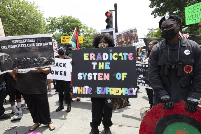 Group of protesters holding signs calling for eradicating white supremacy, Washington, D.C.