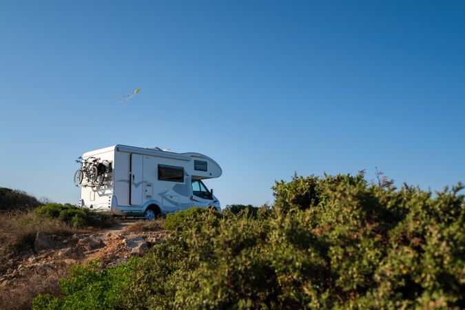 Caravan with bikes driving on hill
