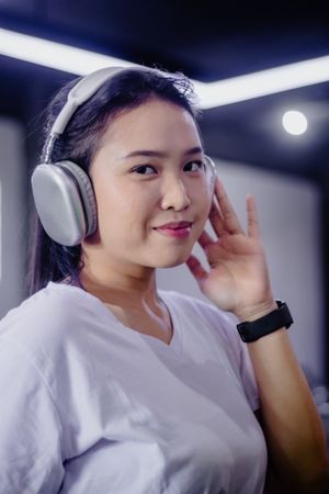 Young woman enjoying music with wireless headphones